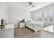 Bright bedroom with shuttered windows, ceiling fan, and coastal-themed decor create a relaxing space at 612 Ozona Village Dr, Palm Harbor, FL 34683