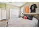Cozy bedroom with neutral tones, plush bedding, and sports memorabilia for a personalized touch at 612 Ozona Village Dr, Palm Harbor, FL 34683