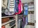 Organized walk-in closet boasts ample shelving, hanging space, drawers, and storage bins for efficient organization at 612 Ozona Village Dr, Palm Harbor, FL 34683