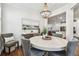 Bright dining room features a chandelier and access to the open-concept kitchen at 612 Ozona Village Dr, Palm Harbor, FL 34683