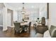 Dining room featuring a chandelier, plantation shutters and modern decorations at 612 Ozona Village Dr, Palm Harbor, FL 34683