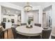 Open-concept dining area with decor, chandelier, and kitchen access at 612 Ozona Village Dr, Palm Harbor, FL 34683