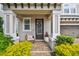 Inviting front porch with room to sit and enjoy the colorful landscaping and sunshine at 612 Ozona Village Dr, Palm Harbor, FL 34683