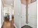 Hallway leading to a dining room that features wood floors and crisp, clean trim at 612 Ozona Village Dr, Palm Harbor, FL 34683