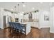 Modern kitchen with white cabinets, stainless steel appliances, pendant lighting and breakfast bar seating at 612 Ozona Village Dr, Palm Harbor, FL 34683