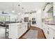 Eat-in kitchen boasts stainless appliances, marble counters, large island, and opens to the living area at 612 Ozona Village Dr, Palm Harbor, FL 34683