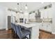 Kitchen features an eat-in island, stainless appliances, and easy access to the dining area at 612 Ozona Village Dr, Palm Harbor, FL 34683