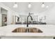 Bright, modern kitchen featuring a marble counter and sink at 612 Ozona Village Dr, Palm Harbor, FL 34683