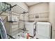 Well-organized laundry room featuring a washer, dryer, storage, and a convenient drying rack at 612 Ozona Village Dr, Palm Harbor, FL 34683