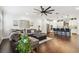 Bright and airy living room featuring a comfortable sofa, hardwood floors, and an open kitchen area at 612 Ozona Village Dr, Palm Harbor, FL 34683