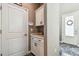Mud room with cabinetry for storage, decor and a glimpse of the front door at 612 Ozona Village Dr, Palm Harbor, FL 34683