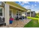 Covered patio featuring brick pavers, comfortable seating, and stylish decor at 612 Ozona Village Dr, Palm Harbor, FL 34683
