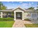 Community pool entrance features lush landscape, mailbox and secure entry access at 612 Ozona Village Dr, Palm Harbor, FL 34683