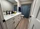 Bright bathroom featuring double sinks, white cabinets, and modern black fixtures at 620 Lithia Pinecrest Rd, Brandon, FL 33511