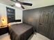 Dark bedroom with built-in shelving and gray walls at 620 Lithia Pinecrest Rd, Brandon, FL 33511