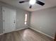 Minimalist empty room with wood-look floors, white trim, and a bright window at 620 Lithia Pinecrest Rd, Brandon, FL 33511