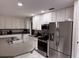 Spacious kitchen with stainless steel appliances, white cabinets, and a functional layout for culinary enthusiasts at 620 Lithia Pinecrest Rd, Brandon, FL 33511