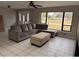 Bright living room features a plush sectional sofa, natural light, and tile floors, perfect for gatherings at 620 Lithia Pinecrest Rd, Brandon, FL 33511