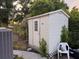 Exterior view of the shed featuring a single door, surrounded by well maintained landscaping at 620 Lithia Pinecrest Rd, Brandon, FL 33511