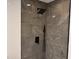 Modern tiled shower with rainfall shower head and sleek black fixtures at 620 Lithia Pinecrest Rd, Brandon, FL 33511