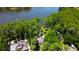 Aerial view of the property highlighting its lush greenery, lake access, and multiple structures at 6341 Discovery Ln, Land O Lakes, FL 34638