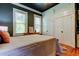 Bedroom with hardwood floors, two windows, black ceilings, dresser, and an ample built-in closet space at 6341 Discovery Ln, Land O Lakes, FL 34638
