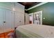 Spacious bedroom featuring hardwood floors, built-in closet space, and an ensuite bathroom with a pedestal sink at 6341 Discovery Ln, Land O Lakes, FL 34638