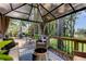 Relaxing outdoor living space featuring a fire pit, gazebo, and dining area on a wooden deck at 6341 Discovery Ln, Land O Lakes, FL 34638