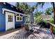 The backyard deck has patio furniture, grill and table and chairs with umbrella at 6341 Discovery Ln, Land O Lakes, FL 34638