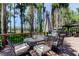 Outdoor dining set on a deck with views of the lake and mature trees at 6341 Discovery Ln, Land O Lakes, FL 34638