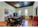 Bright dining area boasts hardwood floors, a chandelier, and ample natural lighting at 6341 Discovery Ln, Land O Lakes, FL 34638