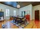 Charming dining room with hardwood floors, modern chandelier, and large windows at 6341 Discovery Ln, Land O Lakes, FL 34638