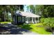 Inviting home exterior with lush lawn, mature trees, and a tranquil setting at 6341 Discovery Ln, Land O Lakes, FL 34638