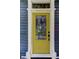 Close-up of a bright yellow front door with glass panel and address number at 6341 Discovery Ln, Land O Lakes, FL 34638