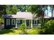 Charming home exterior features a cozy front porch and well-maintained landscaping at 6341 Discovery Ln, Land O Lakes, FL 34638