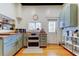 Well-lit kitchen showcases natural wood floors, white appliances, butcher block counters, and sage green cabinetry at 6341 Discovery Ln, Land O Lakes, FL 34638