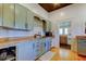 Kitchen with custom blue cabinets, butcher block countertops, and stainless-steel appliances, blending functionality with charm at 6341 Discovery Ln, Land O Lakes, FL 34638