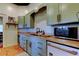 Charming kitchen features sage green cabinets, butcher block countertops, and stainless steel appliances at 6341 Discovery Ln, Land O Lakes, FL 34638