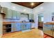 Spacious kitchen boasts sage green cabinetry, butcher block counters, stainless steel appliances, and open layout at 6341 Discovery Ln, Land O Lakes, FL 34638