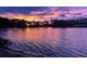 Scenic lake view at dusk with vibrant sky colors reflected in the calm water at 6341 Discovery Ln, Land O Lakes, FL 34638