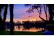 Picturesque lakeside with chairs, sunset reflections, and Spanish moss trees at 6341 Discovery Ln, Land O Lakes, FL 34638