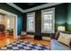 Elegant living room with hardwood floors, dark green walls, and stylish decor at 6341 Discovery Ln, Land O Lakes, FL 34638