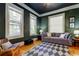Cozy living room featuring hardwood floors, large windows, and comfortable seating at 6341 Discovery Ln, Land O Lakes, FL 34638