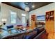 Bright living room featuring a comfortable leather couch, hardwood floors, and ample natural light at 6341 Discovery Ln, Land O Lakes, FL 34638