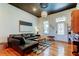 Cozy living room showcases modern decor, a comfortable leather couch, and hardwood floors at 6341 Discovery Ln, Land O Lakes, FL 34638