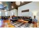 Comfortable living area open to dining room with a stylish black leather couch and hardwood floors at 6341 Discovery Ln, Land O Lakes, FL 34638