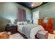 Cozy main bedroom featuring a queen bed, modern decor, and lots of closet space at 6341 Discovery Ln, Land O Lakes, FL 34638
