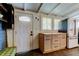 Mudroom connecting to a kitchen featuring black hexagon floors, and a charming cabinet at 6341 Discovery Ln, Land O Lakes, FL 34638