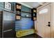 Stylish mudroom with blue plank walls, a decorative bench, and functional storage solutions at 6341 Discovery Ln, Land O Lakes, FL 34638