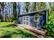 Exterior view of a blue outbuilding with double doors and a wooden deck at 6341 Discovery Ln, Land O Lakes, FL 34638